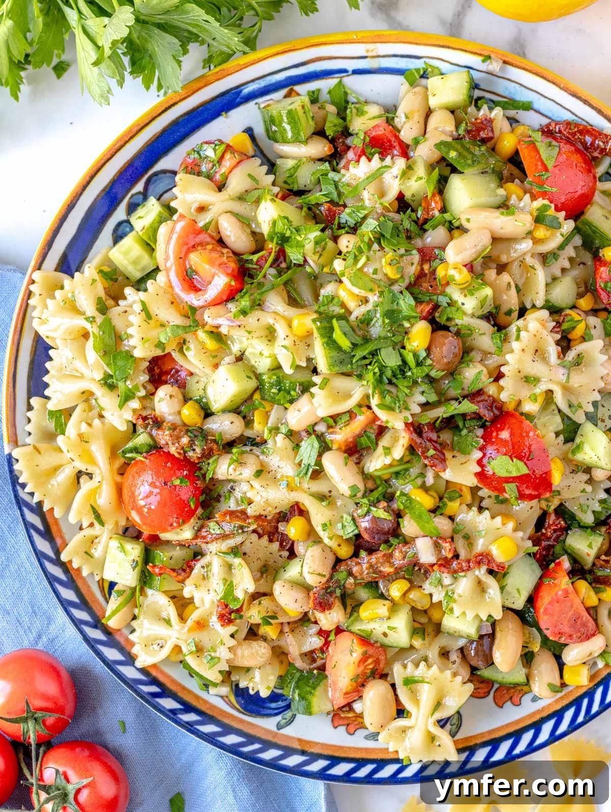 Vibrant Vegan Pasta Salad 4 Close-up of vibrant bowtie pasta salad ingredients being mixed.