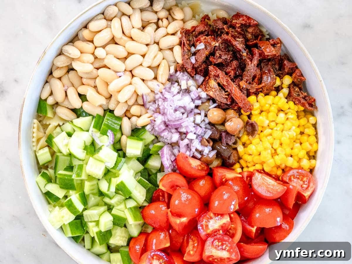 Vibrant Vegan Pasta Salad 6 Chopped fresh ingredients for vegan pasta salad gathered in a white bowl.