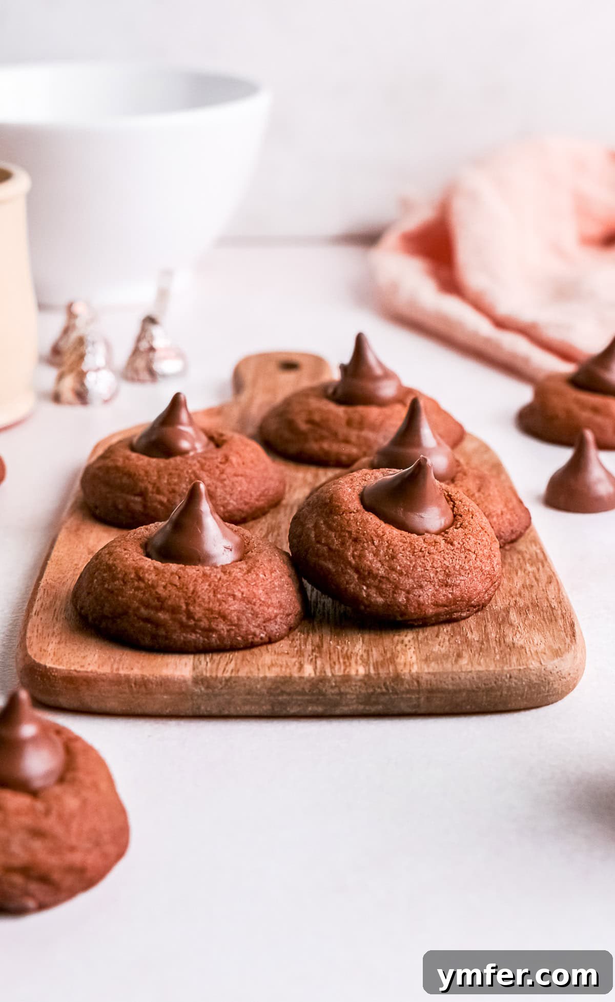 Chocolate Kissed Delights 5 A collection of freshly baked Chocolate Blossom Cookies arranged on a rustic wooden serving tray, ready to be enjoyed.