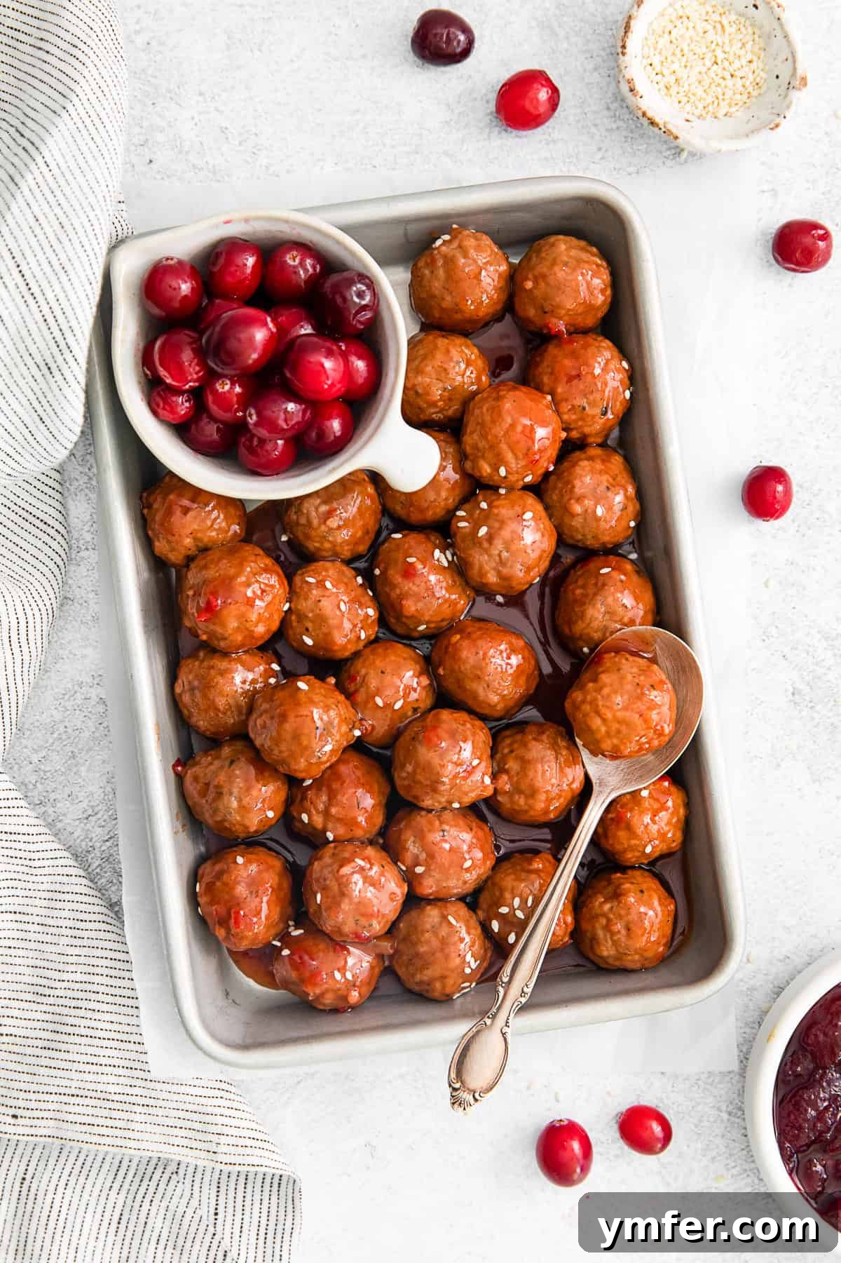 Sweet and Tangy Slow Cooker Cranberry Meatballs 2 Slow Cooker Cranberry Meatballs, garnished with fresh herbs
