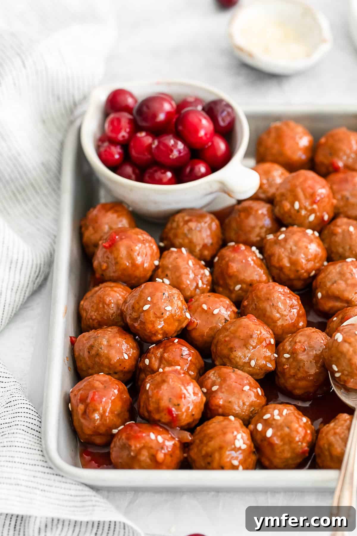 Sweet and Tangy Slow Cooker Cranberry Meatballs 4 Slow Cooker Cranberry Meatballs served in a bowl with toothpicks