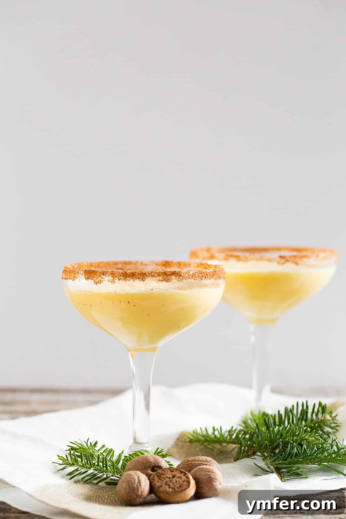 Holiday Cheer Martini 5 An Eggnog Martini in a sleek glass, beautifully garnished with a generous dusting of fresh nutmeg on top, ready to be served.