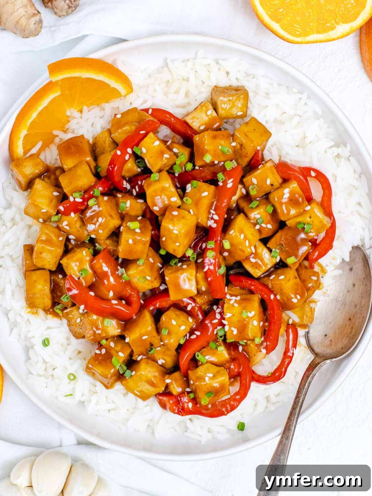 Zesty Orange Tofu 2 high protein orange tofu with a silver spoon.
