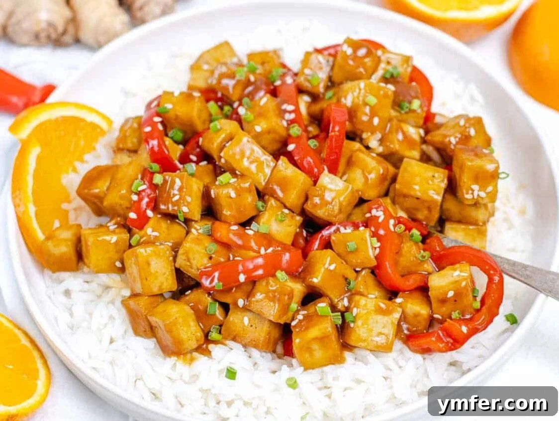 Zesty Orange Tofu 14 Orange Tofu on a plate with rice and a spoon