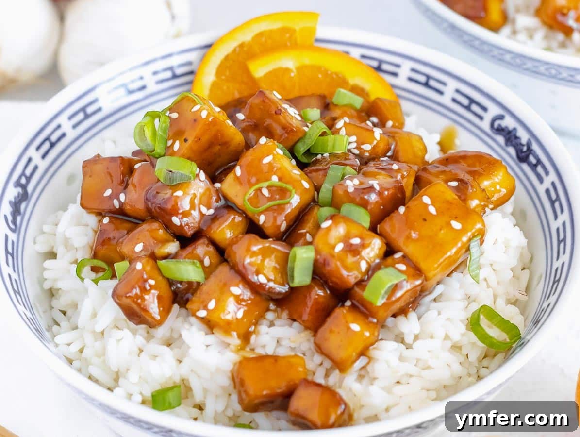 Zesty Orange Tofu 16 orange tofu with rice and green onions in a bowl