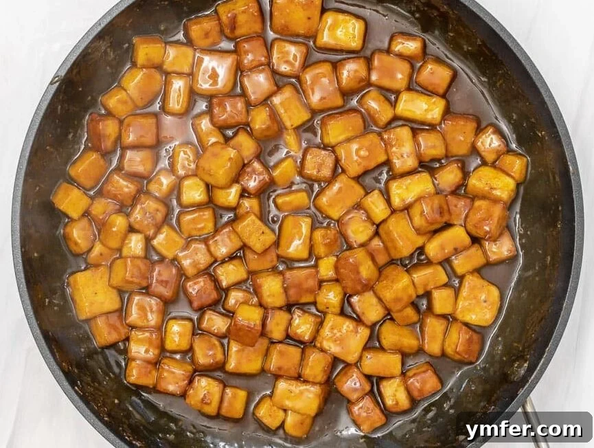 Zesty Orange Tofu 3 oven-baked tofu cubes coated in the orange sauce