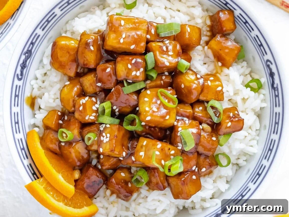 Zesty Orange Tofu 17 orange tofu with rice and green onions in a bowl