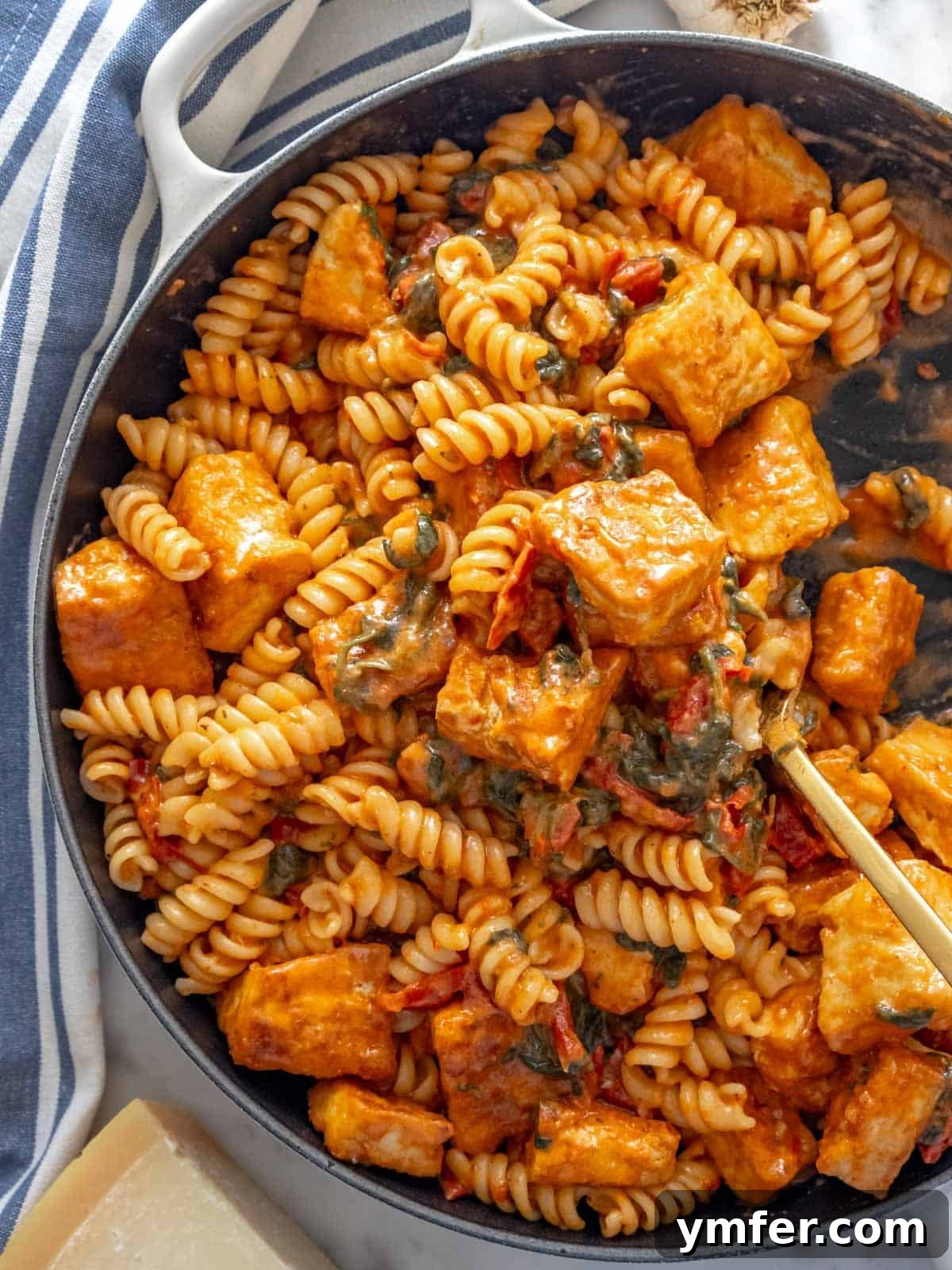 Marry me tofu pasta in a large skillet, garnished with fresh basil.