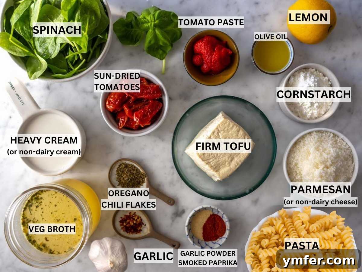 Fresh ingredients for creamy marry me tofu pasta laid out on a marble table.