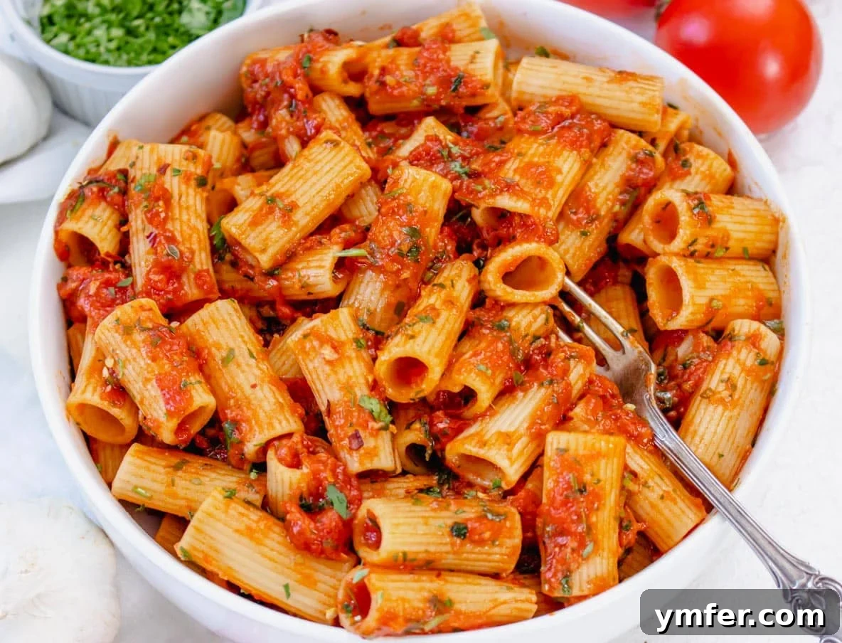 Fiery Rigatoni 5 close-up of rigatoni arrabbiata in a bowl, showing the sauce clinging to the pasta