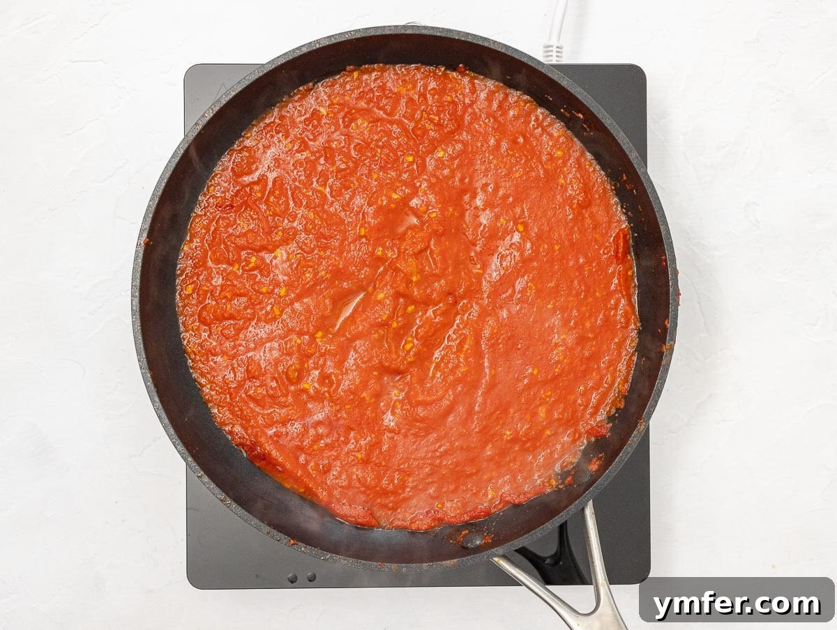 Fiery Rigatoni 8 simmering arrabbiata sauce in a large pan