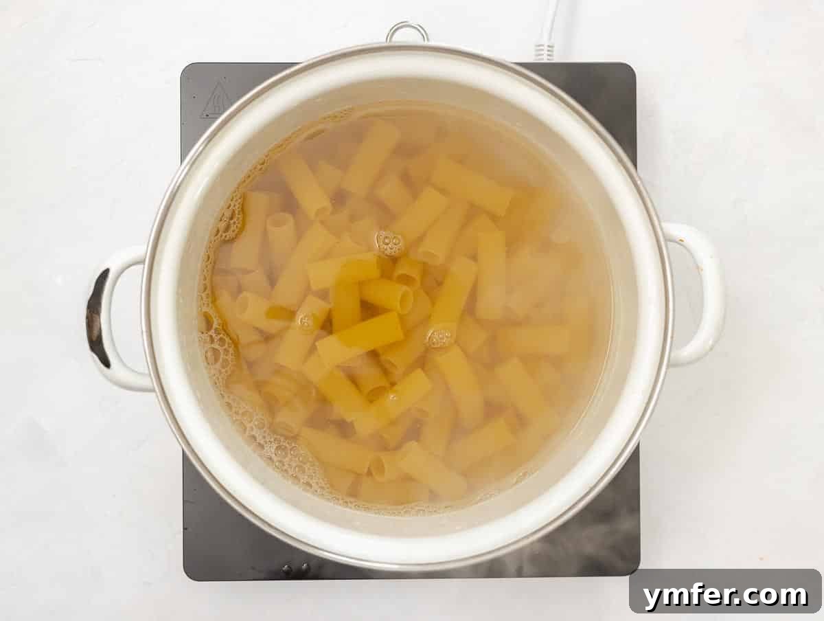 Fiery Rigatoni 9 cooking rigatoni pasta in a pot of boiling salted water