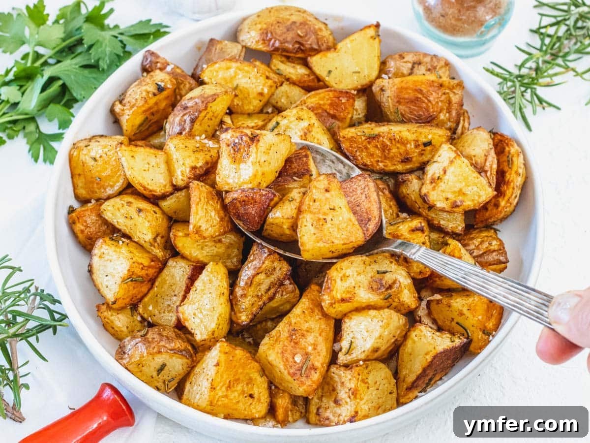 45 Delightful Vegetable Sides 14 Roasted Potatoes with hand and a silver spoon