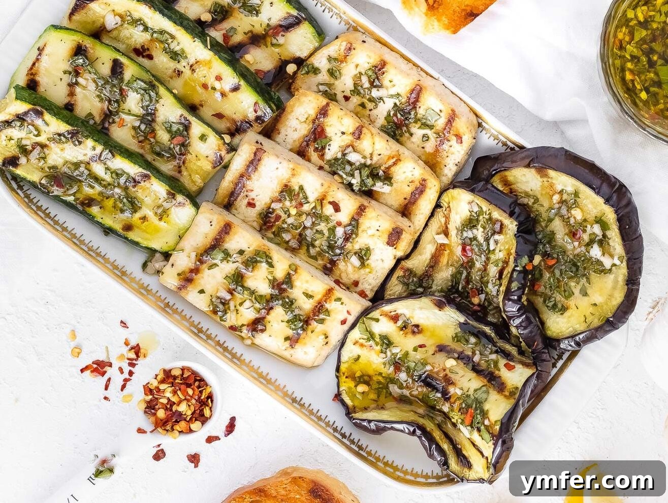45 Delightful Vegetable Sides 37 grilled eggplant on a platter with grilled tofu, grilled zucchini and seasoned with chimichurri