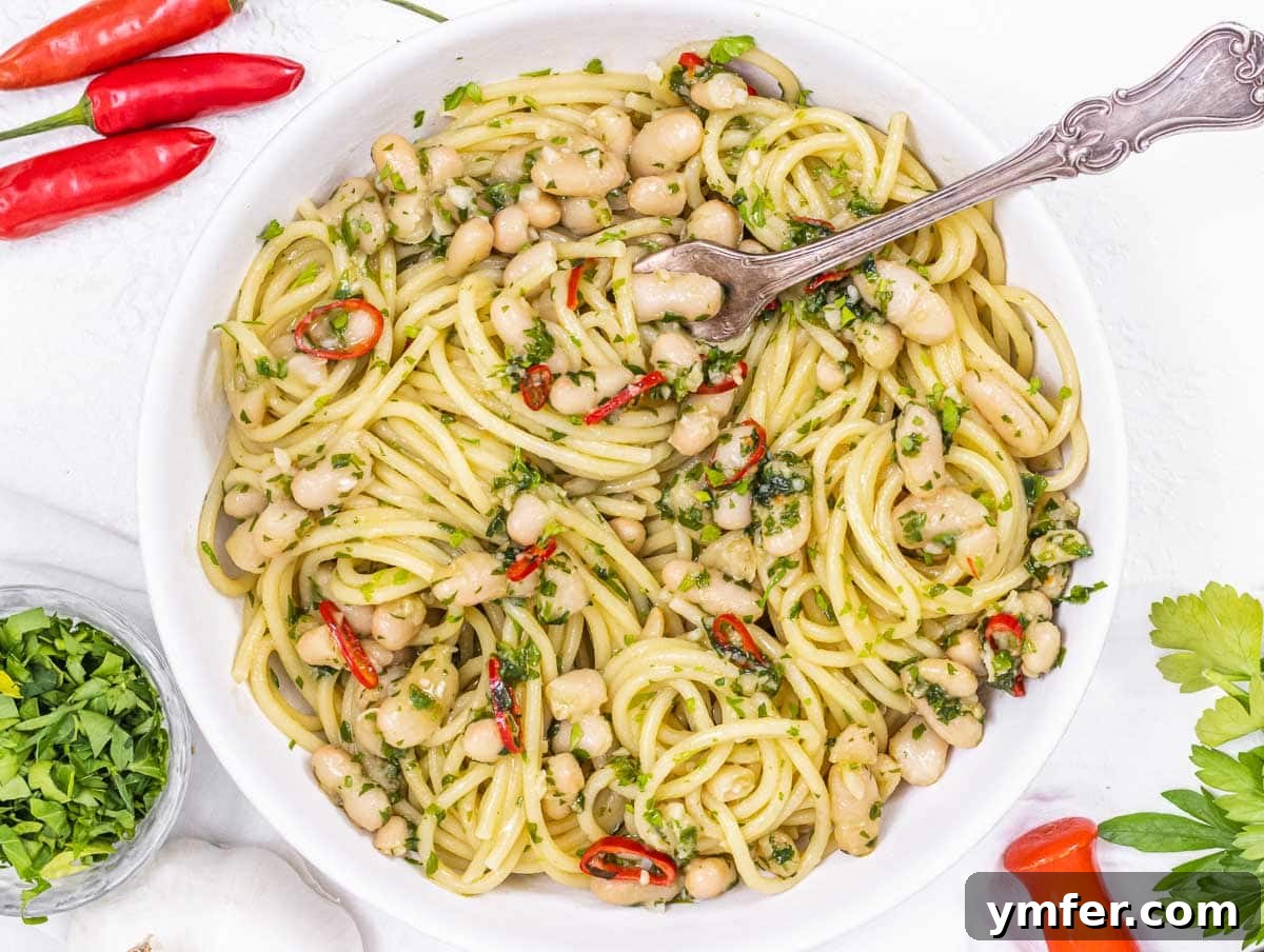 30 Quick & Wholesome Vegan Lunch Recipes 21 Aglio olio beans with a fork and chili