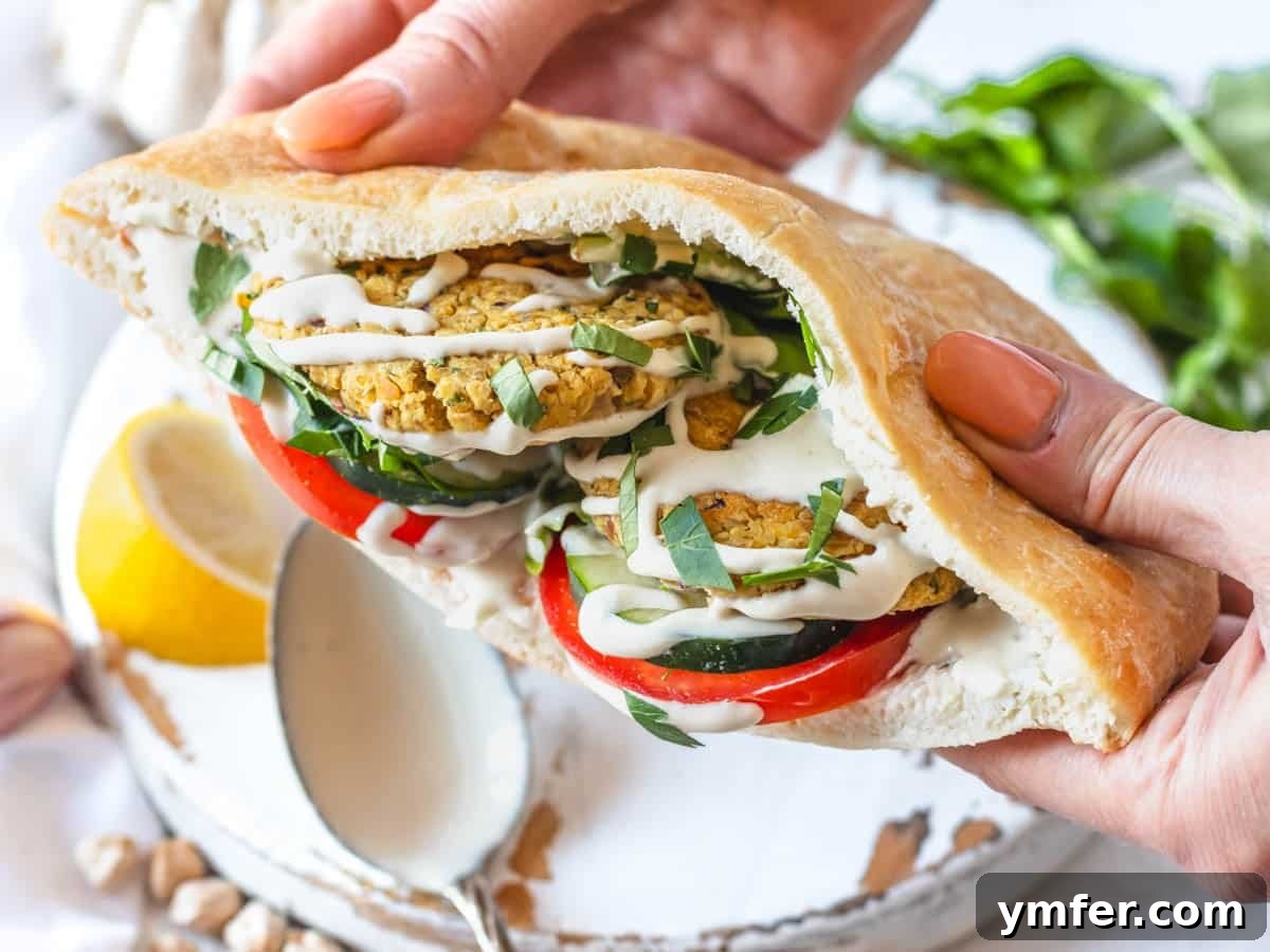 Feast on Plants: 35 Vibrant Recipes 15 Chickpea fritters nestled in pita bread with fresh vegetables and creamy tahini sauce.