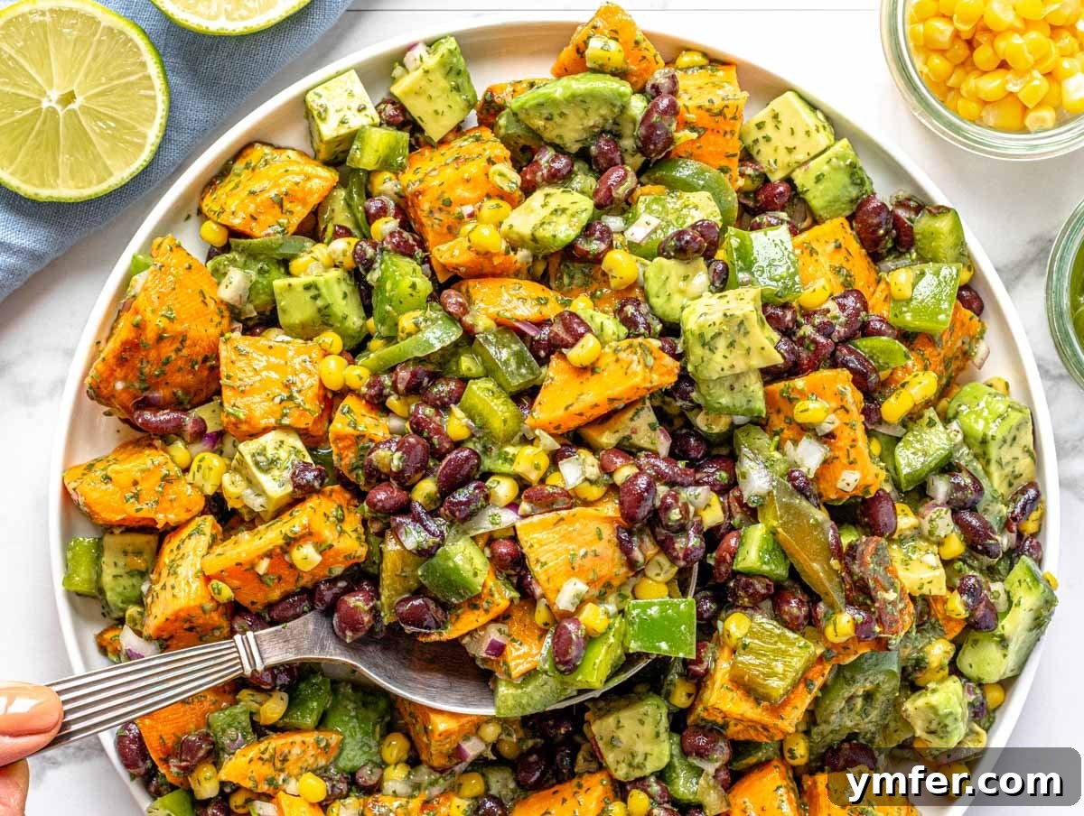 Feast on Plants: 35 Vibrant Recipes 16 Black bean salad with a hand holding a lime wedge on the side.