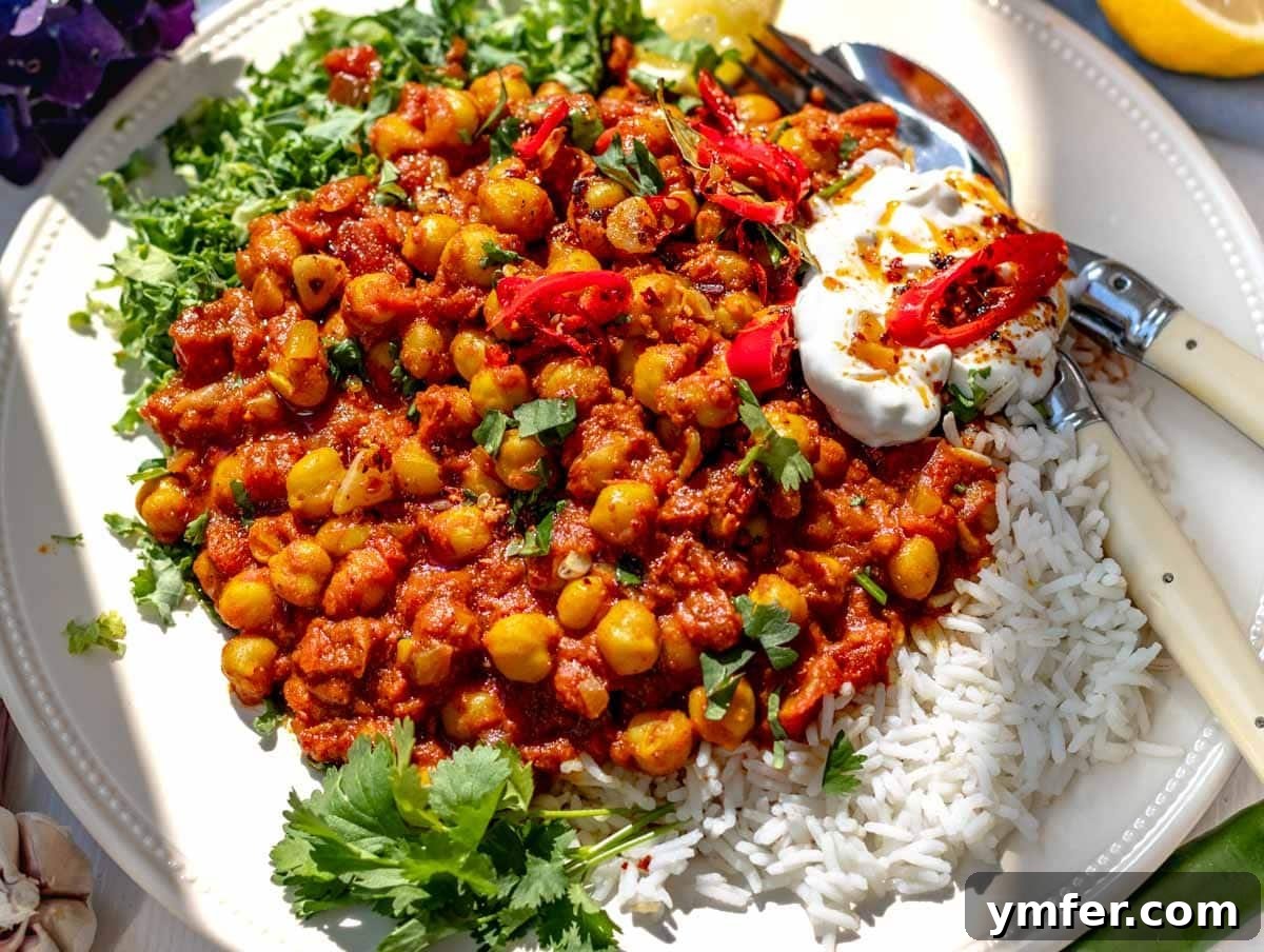Feast on Plants: 35 Vibrant Recipes 18 Chana masala served with fluffy rice, fresh kale, and elegant cutlery.