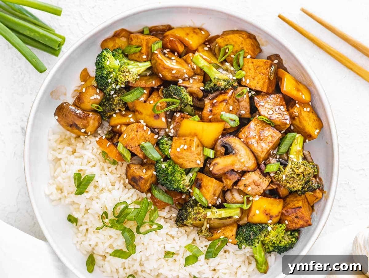 Feast on Plants: 35 Vibrant Recipes 21 Tofu stir-fry with white rice and vibrant broccoli florets.