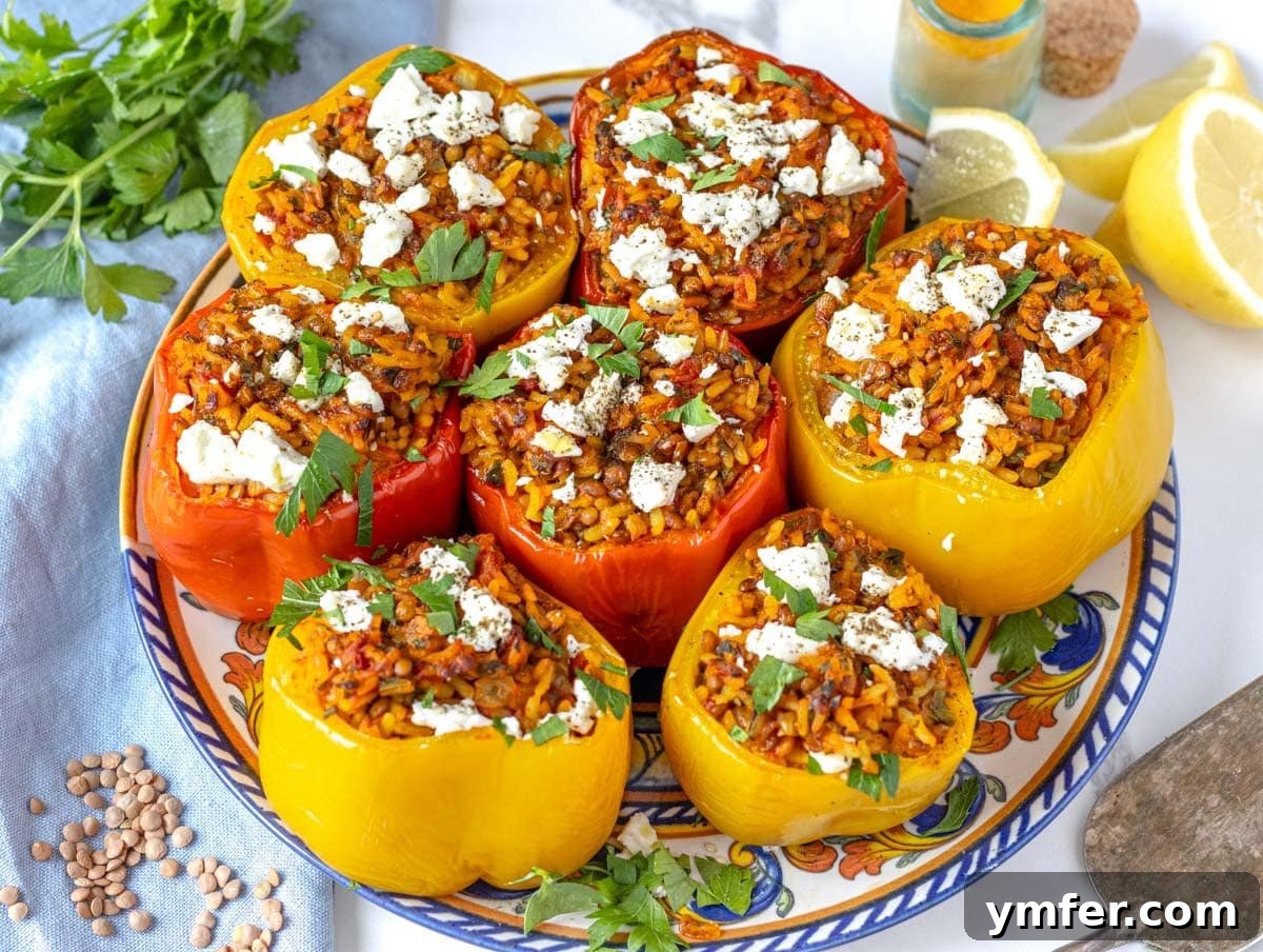 Feast on Plants: 35 Vibrant Recipes 22 Stuffed bell peppers garnished with feta cheese and fresh parsley on a plate.
