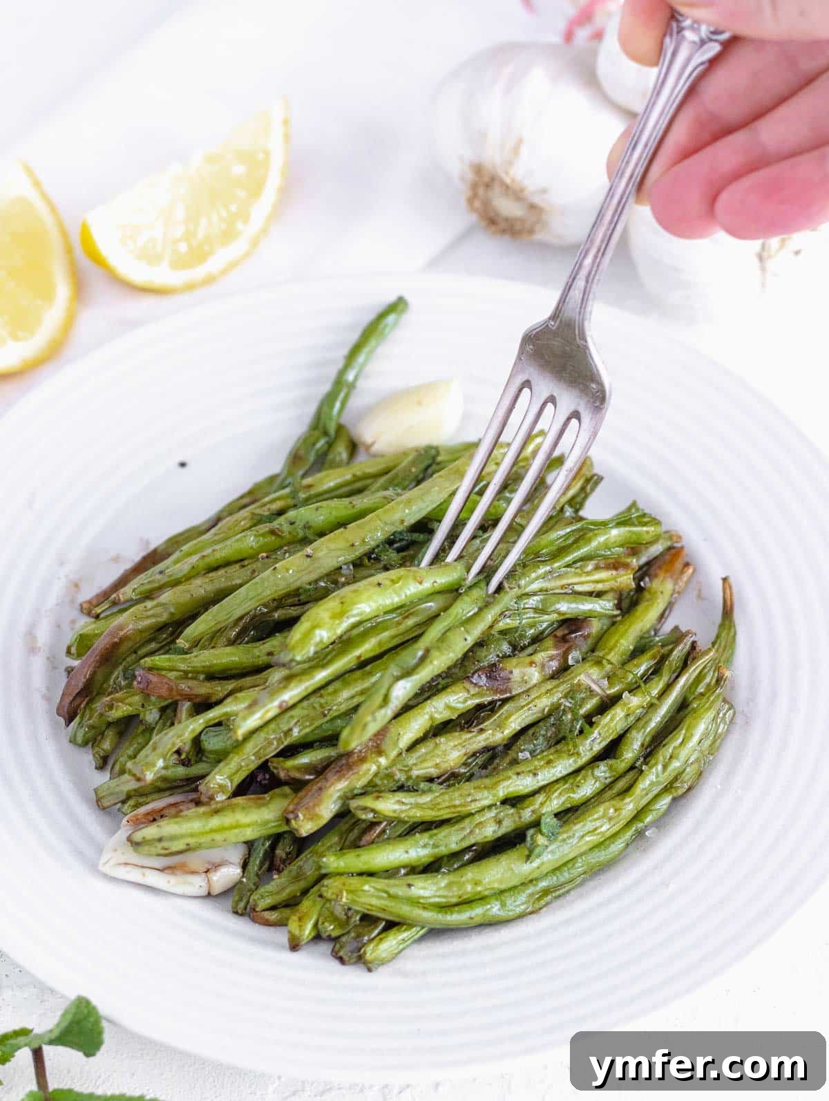 Crispy Air Fryer Green Beans 3 A serving of air fryer green beans on a clean white plate