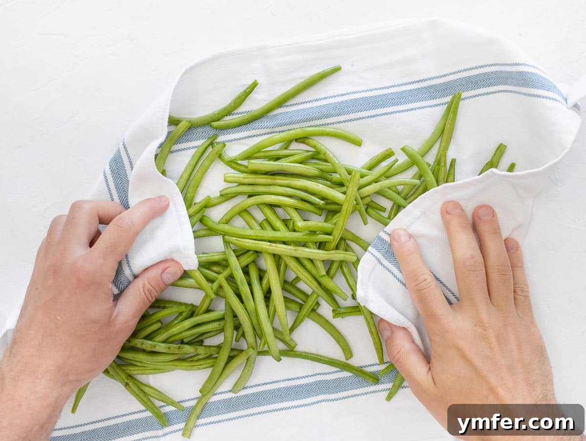 Crispy Air Fryer Green Beans 7 Patting dry green beans with a kitchen towel