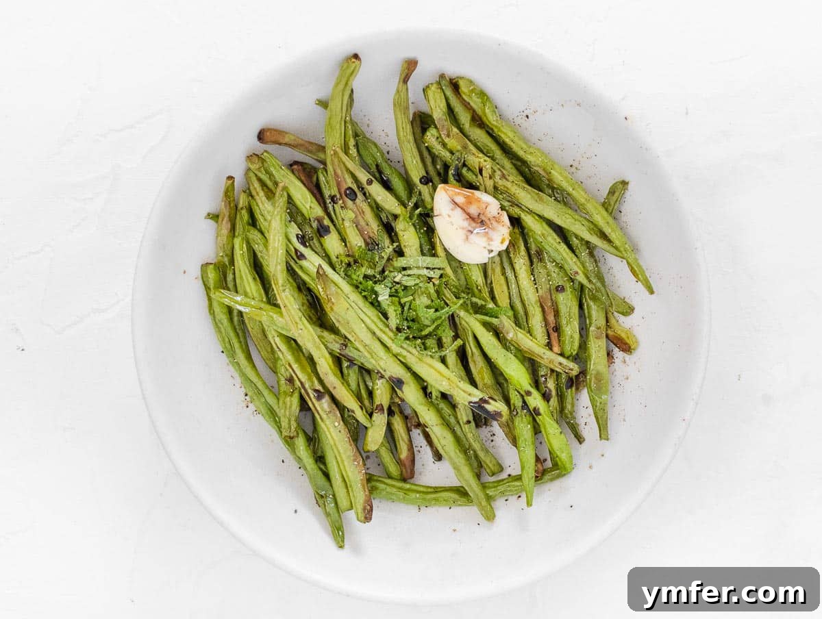 Crispy Air Fryer Green Beans 10 Air-fried green beans seasoned with olive oil, garlic, balsamic vinegar, and pepper, ready to eat