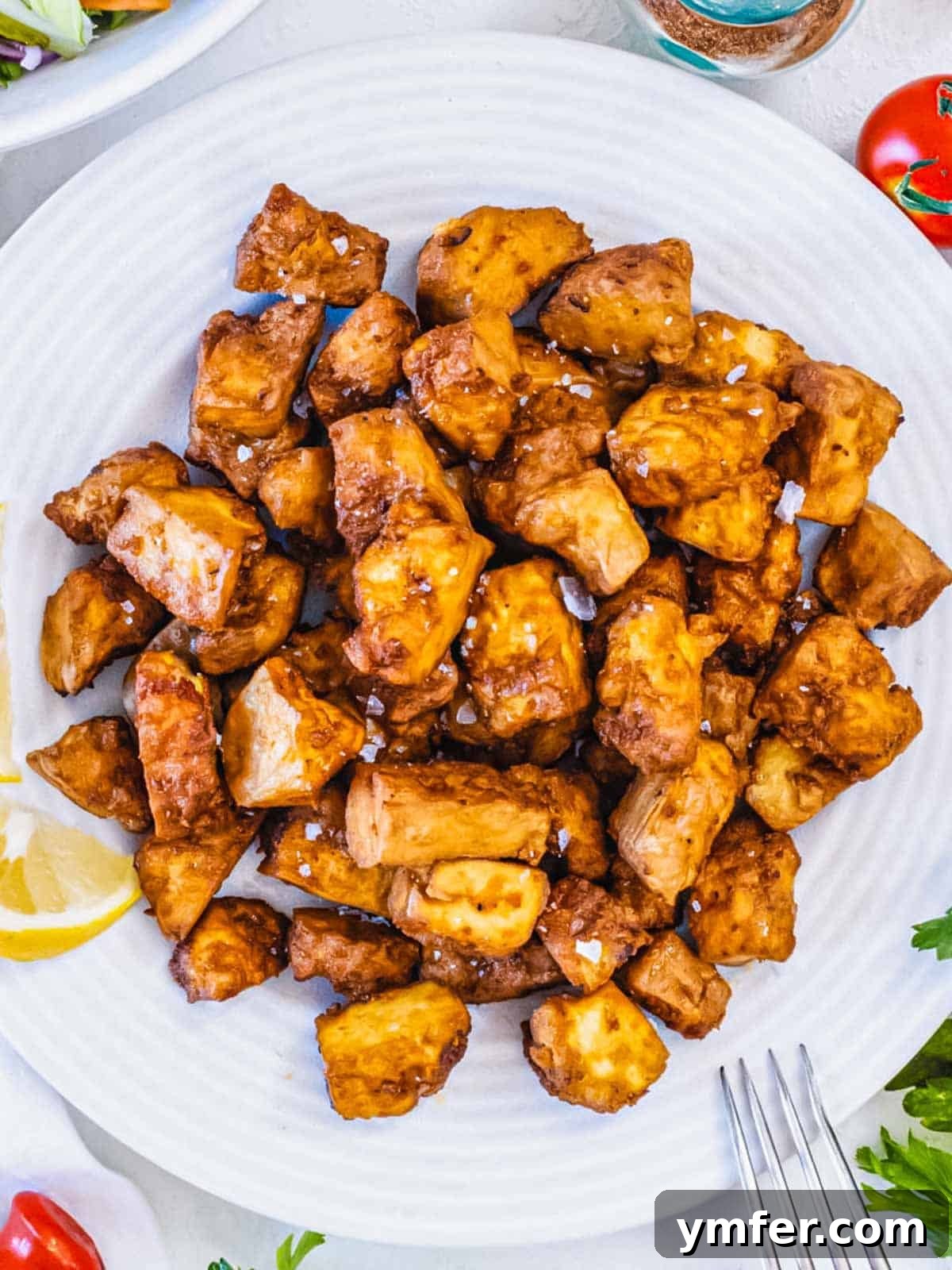 Effortless Crispy Air Fryer Tofu 2 Crispy Air fryer tofu pieces ready to be served.