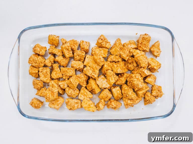 Tofu mixed with oil and spices, ready for air frying.