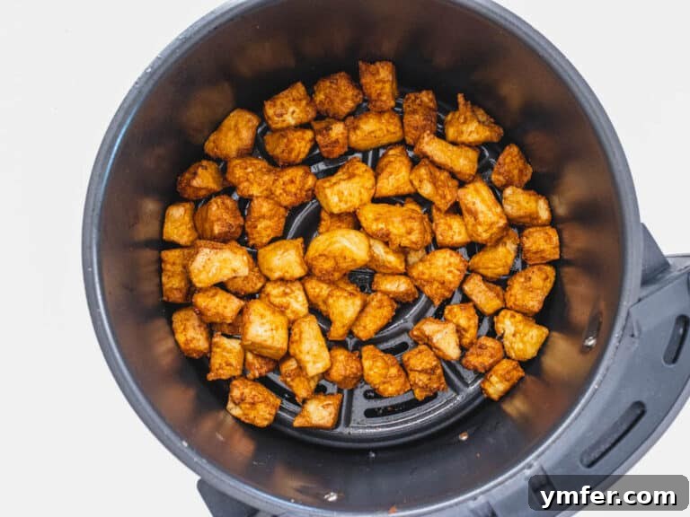 Air fryer tofu after cooking, golden and crispy.
