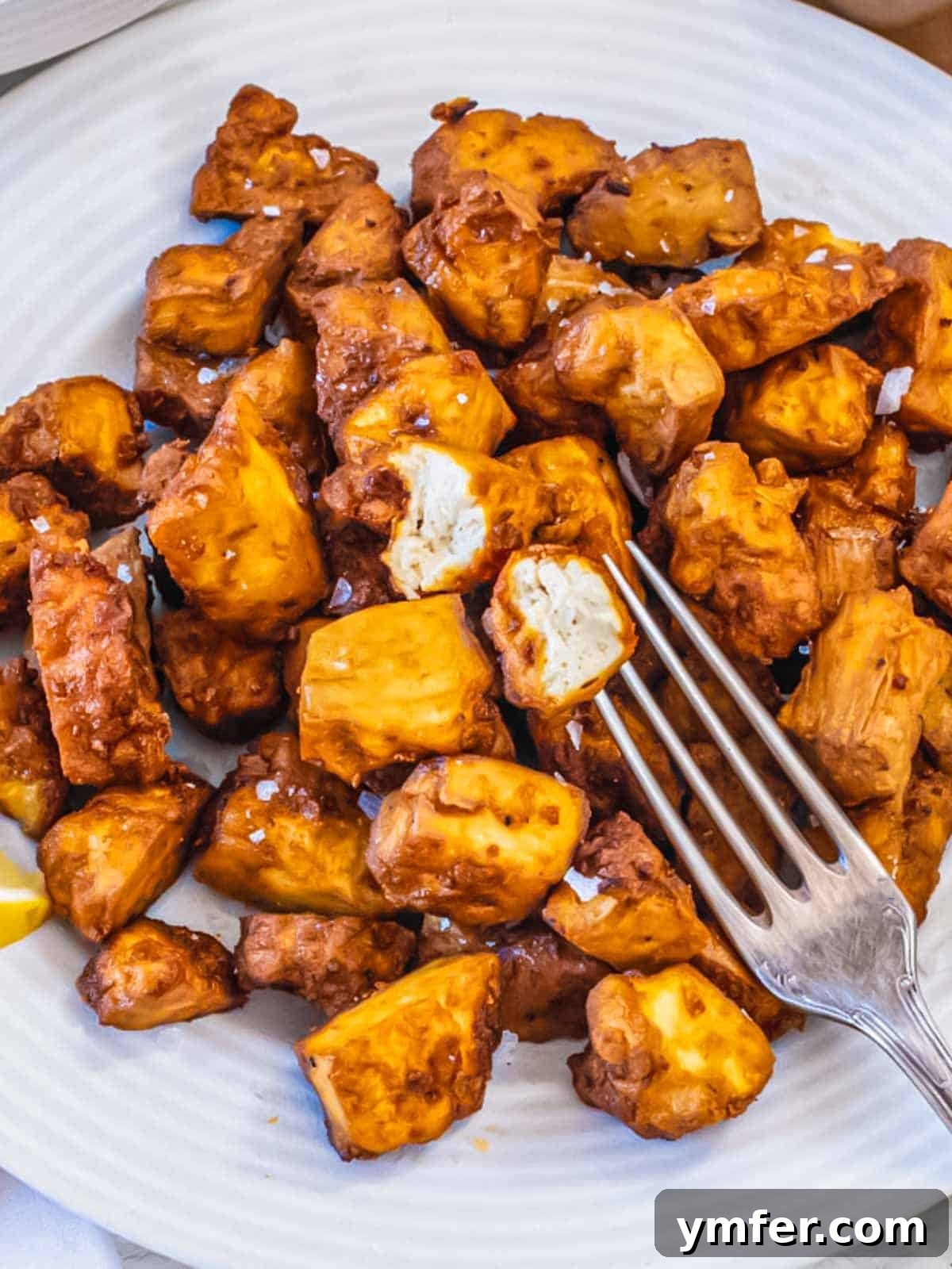 Effortless Crispy Air Fryer Tofu 3 Air fryer tofu recipe, close-up shot of crispy tofu cubes.