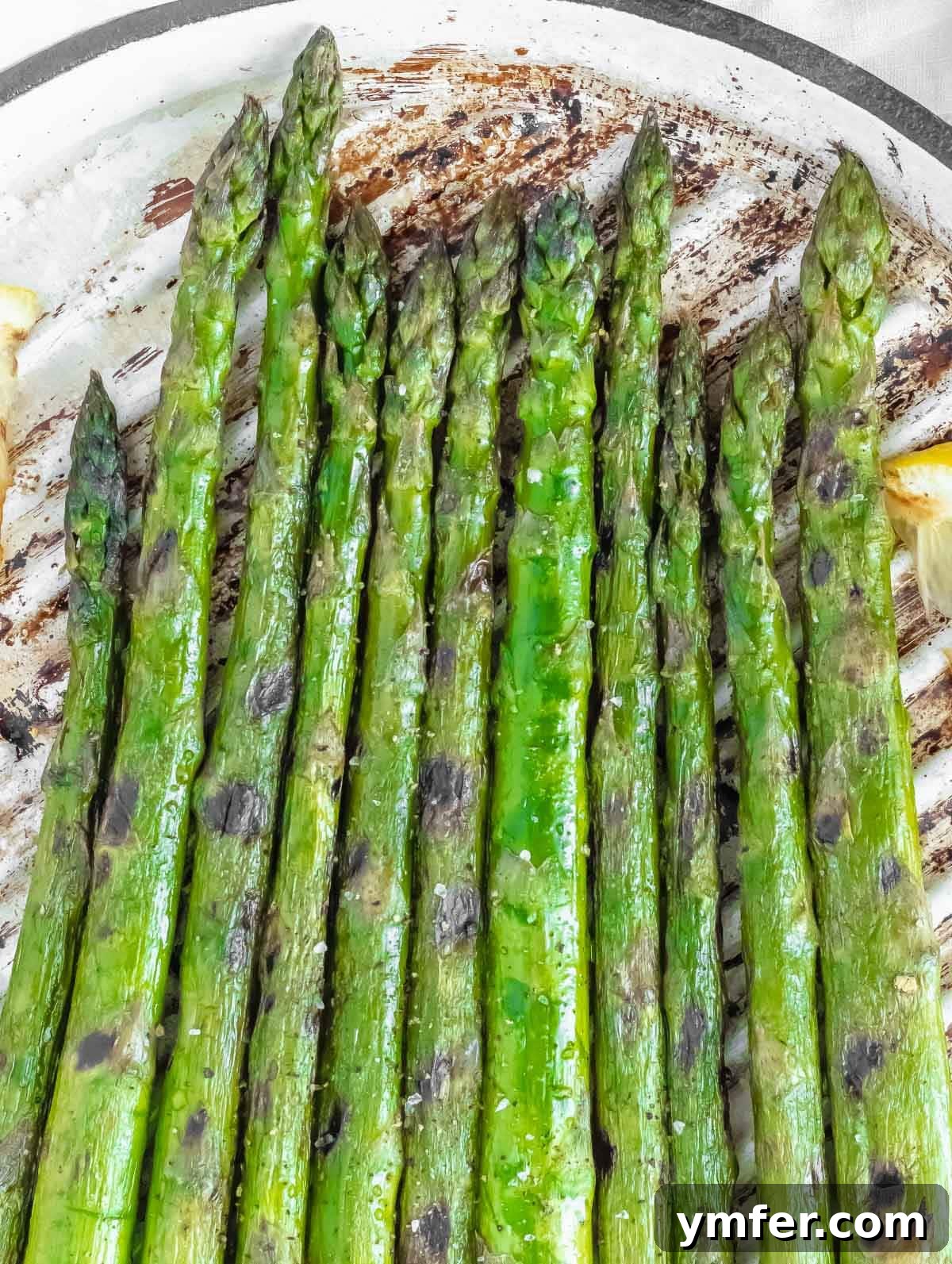 Grilled asparagus with olive oil and lemon wedges, ready to be served