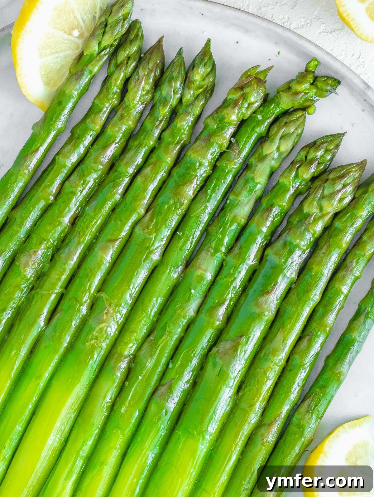 Perfectly Boiled Asparagus 3 Platter of boiled asparagus spears with fresh lemon wedges for garnish