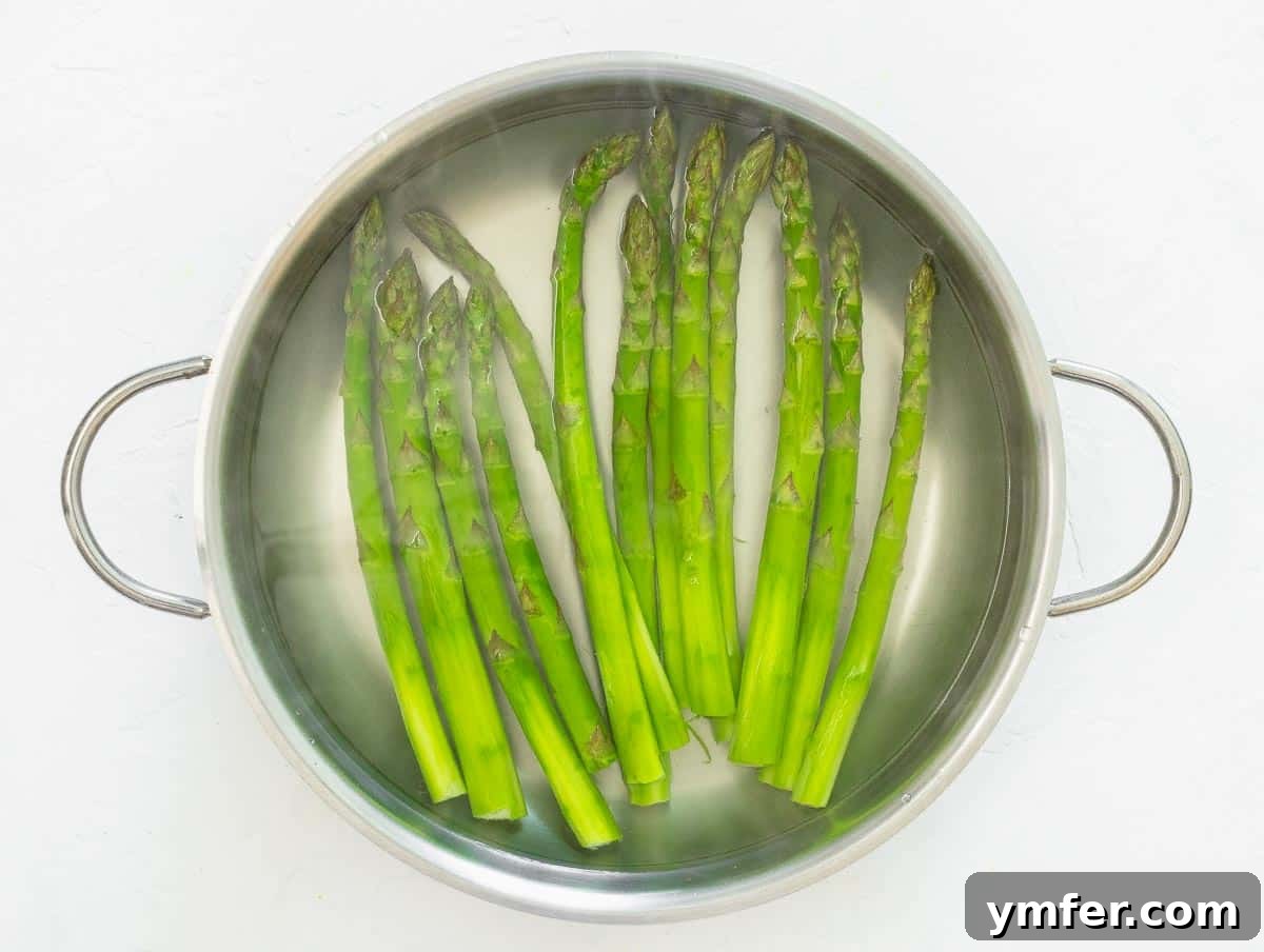 Perfectly Boiled Asparagus 7 Asparagus spears boiling in a large pan of salted water