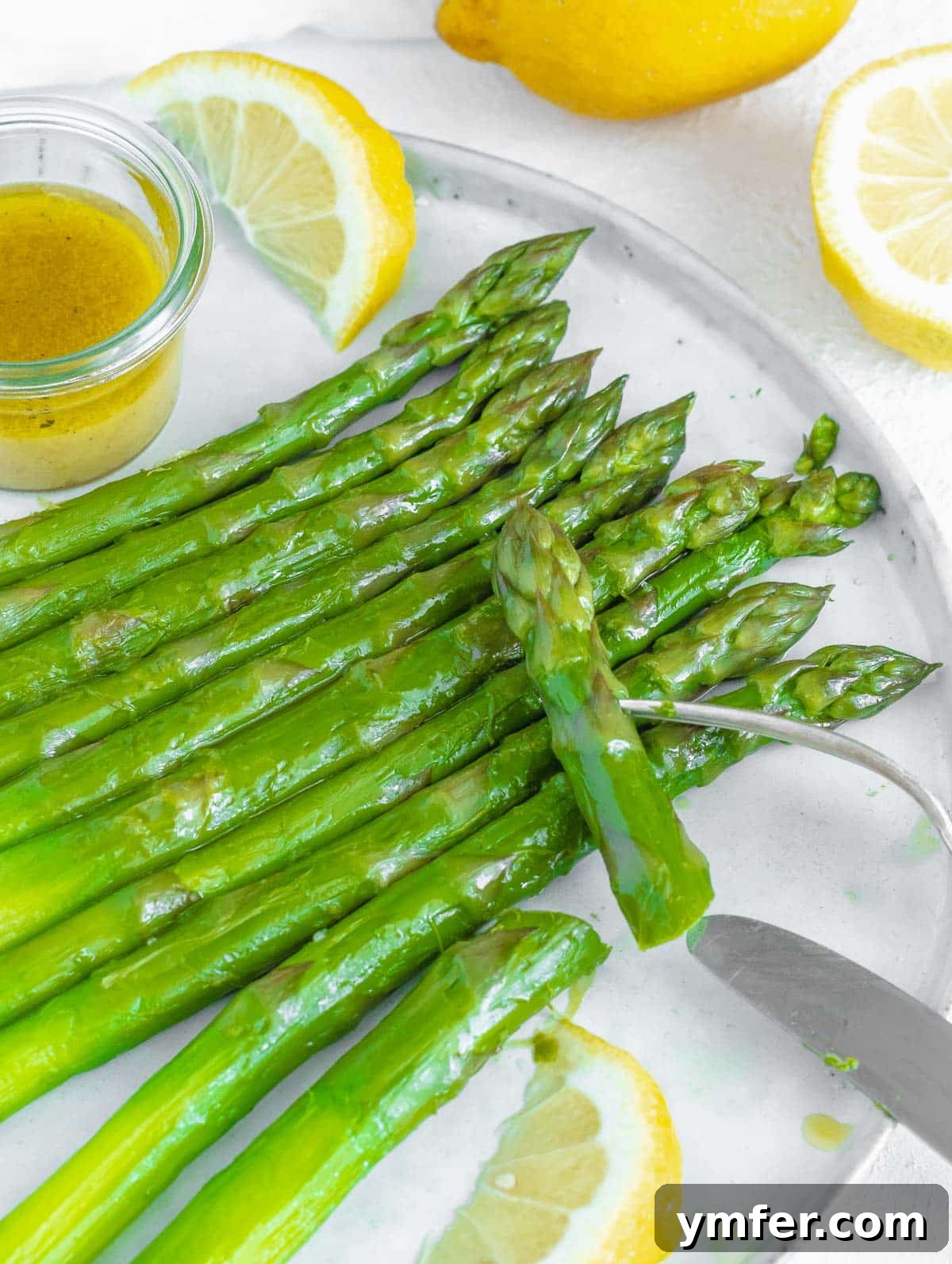 Perfectly Boiled Asparagus 9 Boiled asparagus with a generous topping of mustard vinaigrette, with a fork ready to serve