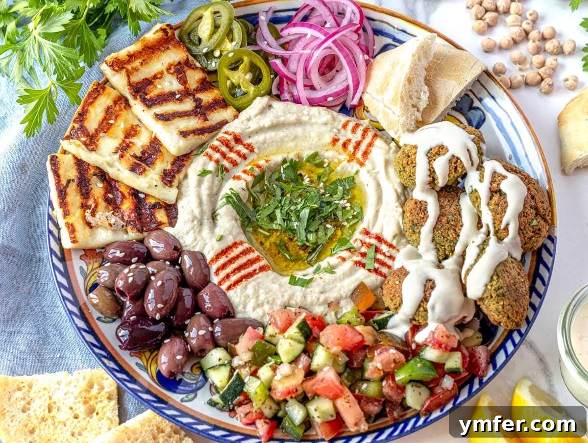 Silky Tahini Drizzle 7 Creamy tahini sauce drizzled over a Middle Eastern mezze platter featuring falafel, hummus, and fresh herbs.