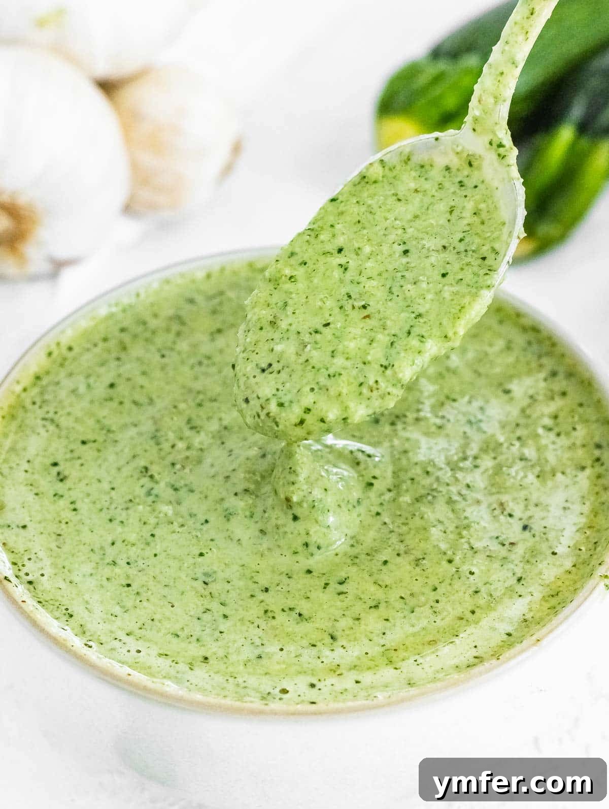 Silently, I'll translate "Zucchini Pesto" to English, verify it's already English, and then provide it as the final, unique title without any extra text or formatting, ensuring no special characters like asterisks or introductory phrases are included. 2 Fresh Zucchini Pesto in a bowl, garnished with basil leaves, ready to be served