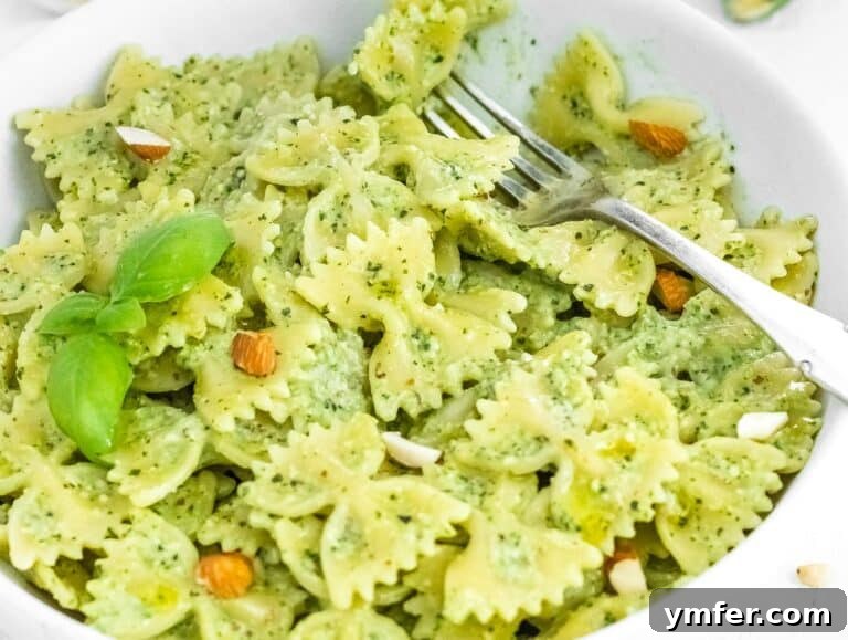 Silently, I'll translate "Zucchini Pesto" to English, verify it's already English, and then provide it as the final, unique title without any extra text or formatting, ensuring no special characters like asterisks or introductory phrases are included. 20 Delicious zucchini pesto pasta dish in a serving bowl