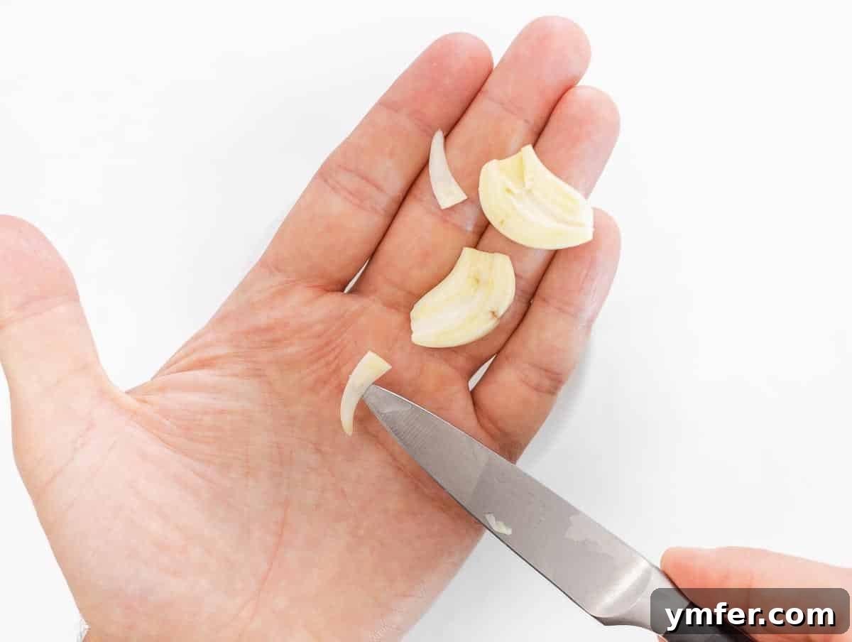 Silently, I'll translate "Zucchini Pesto" to English, verify it's already English, and then provide it as the final, unique title without any extra text or formatting, ensuring no special characters like asterisks or introductory phrases are included. 6 Someone removing the core from a garlic clove with a small knife
