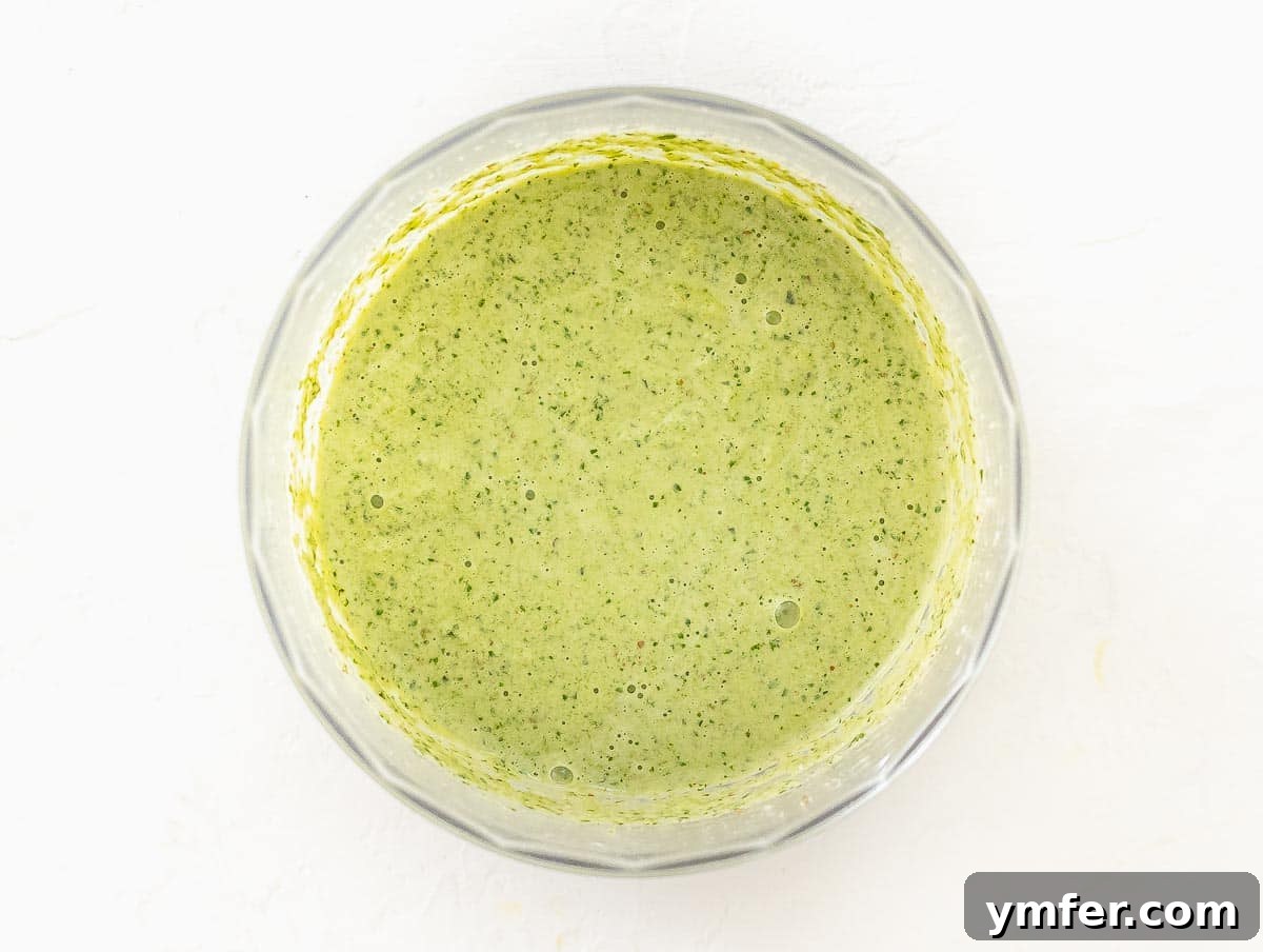 Silently, I'll translate "Zucchini Pesto" to English, verify it's already English, and then provide it as the final, unique title without any extra text or formatting, ensuring no special characters like asterisks or introductory phrases are included. 10 Freshly made zucchini pesto on a spoon, showing its vibrant green color