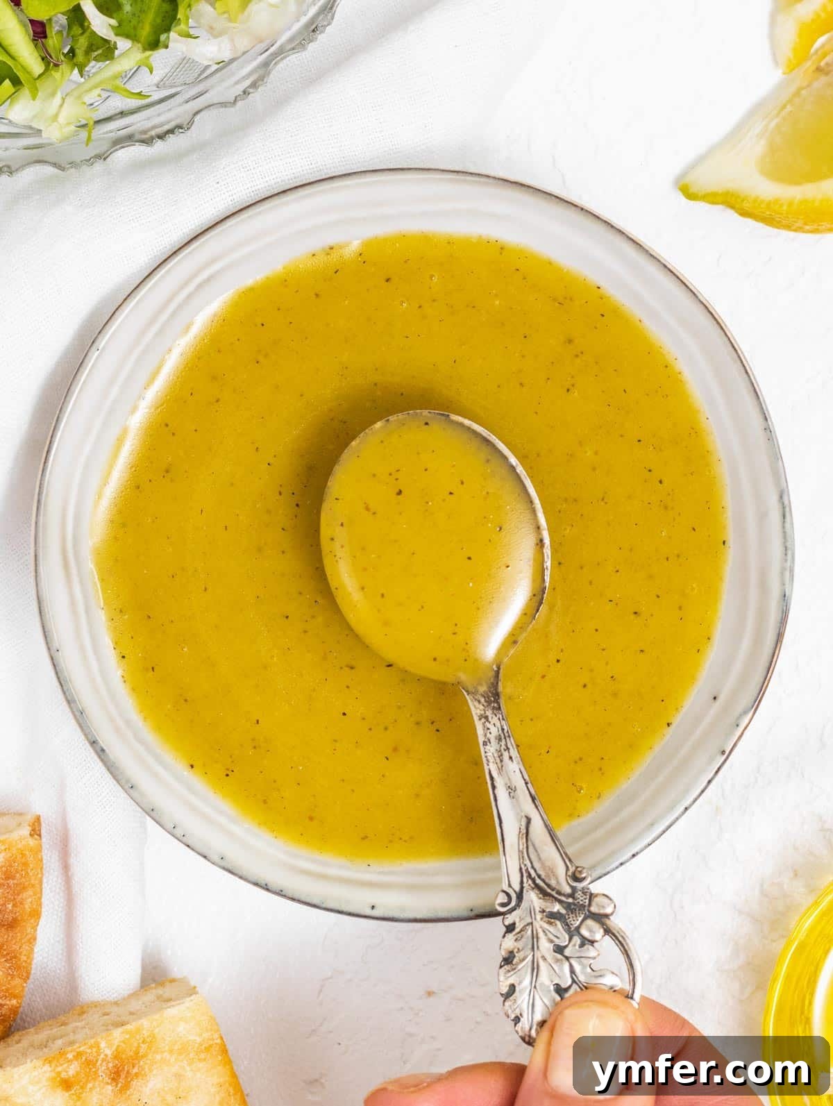 Golden Honey Mustard Bliss 2 Honey mustard dressing being drizzled onto food by a hand, emphasizing its versatility