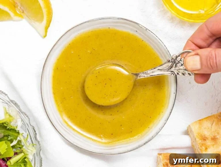 Golden Honey Mustard Bliss 18 Creamy honey mustard dressing in a bowl with a spoon