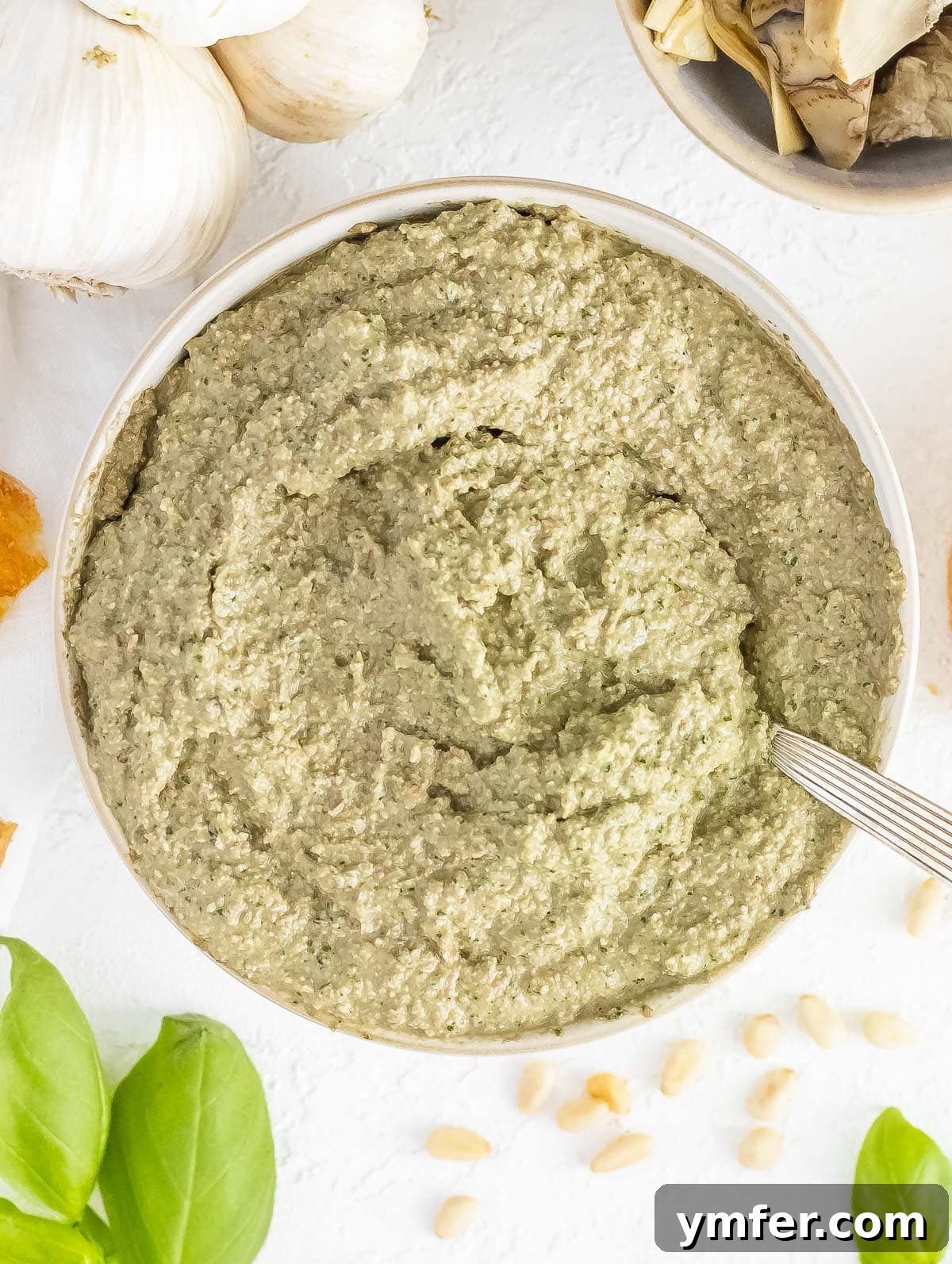 Savory Artichoke Spread 2 Freshly made artichoke pesto in a bowl, ready to be served, highlighting its creamy texture and green hue