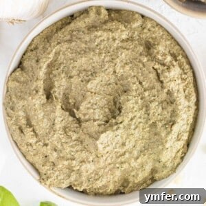 Close-up of creamy artichoke pesto in a white bowl, ready to be enjoyed