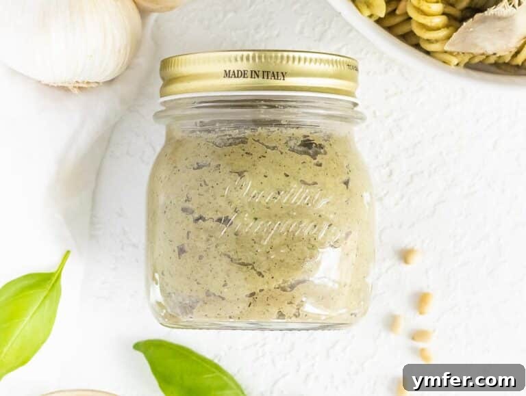 Artichoke pesto stored in a jar with olive oil layer, ready for freezing