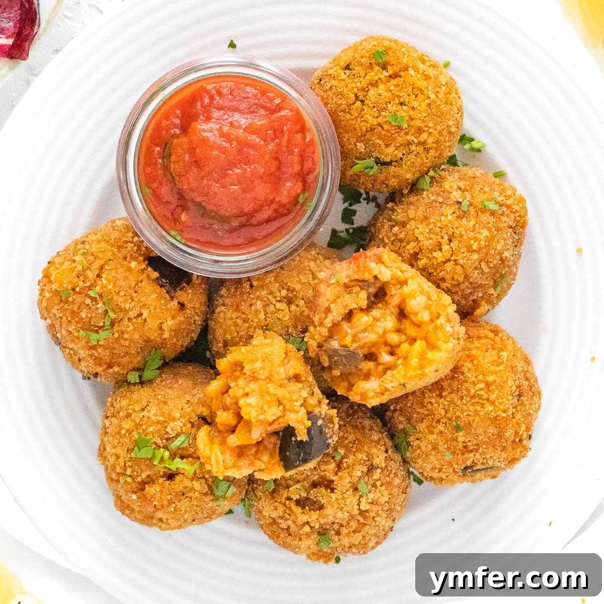 Eggplant Elevated 30 Exciting Recipes 7 Italian Rice Balls served with a side of marinara sauce.