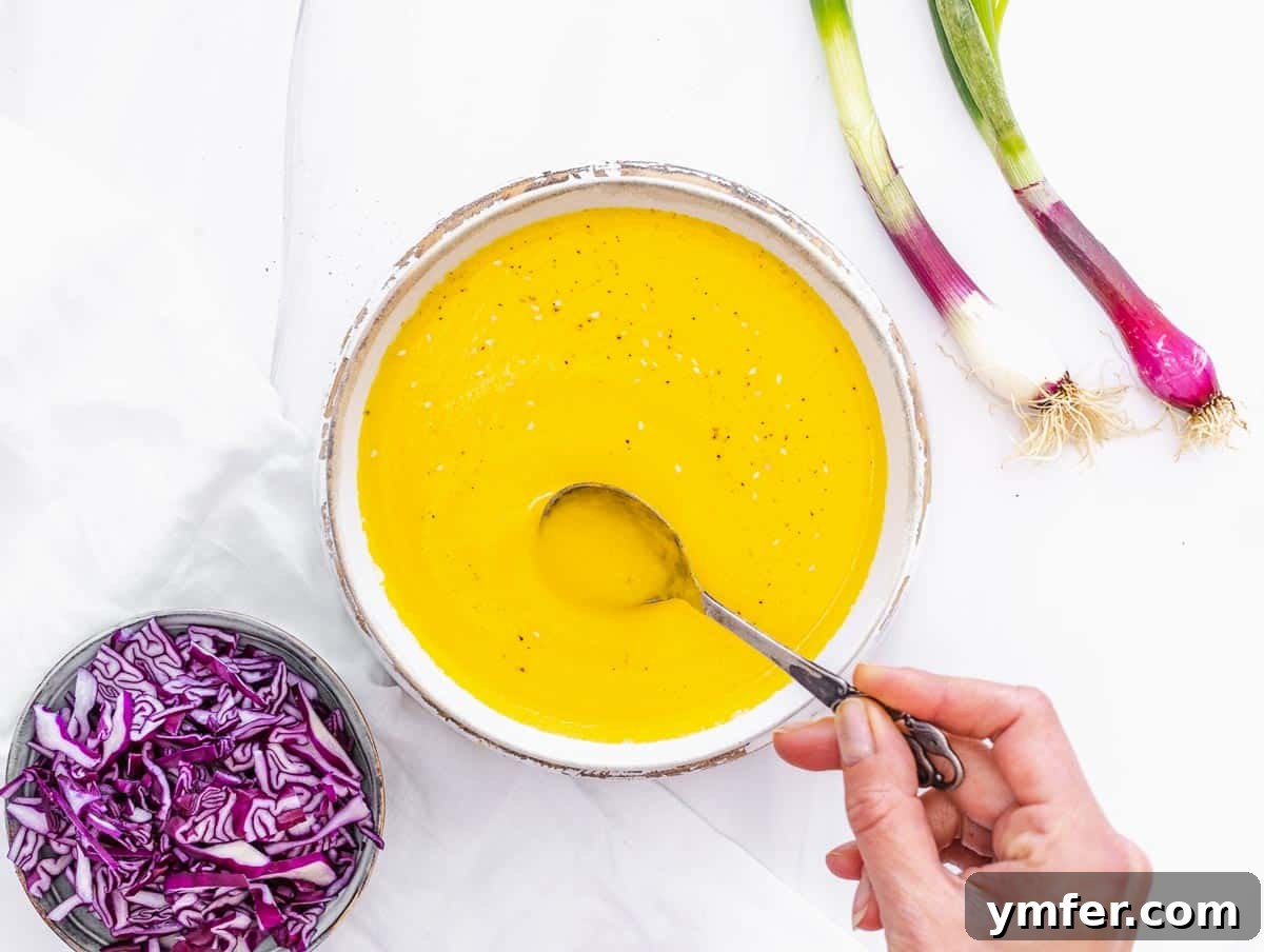 Vibrant Carrot Ginger Dressing 11 Carrot ginger dressing served in a small bowl, ready as a dip.