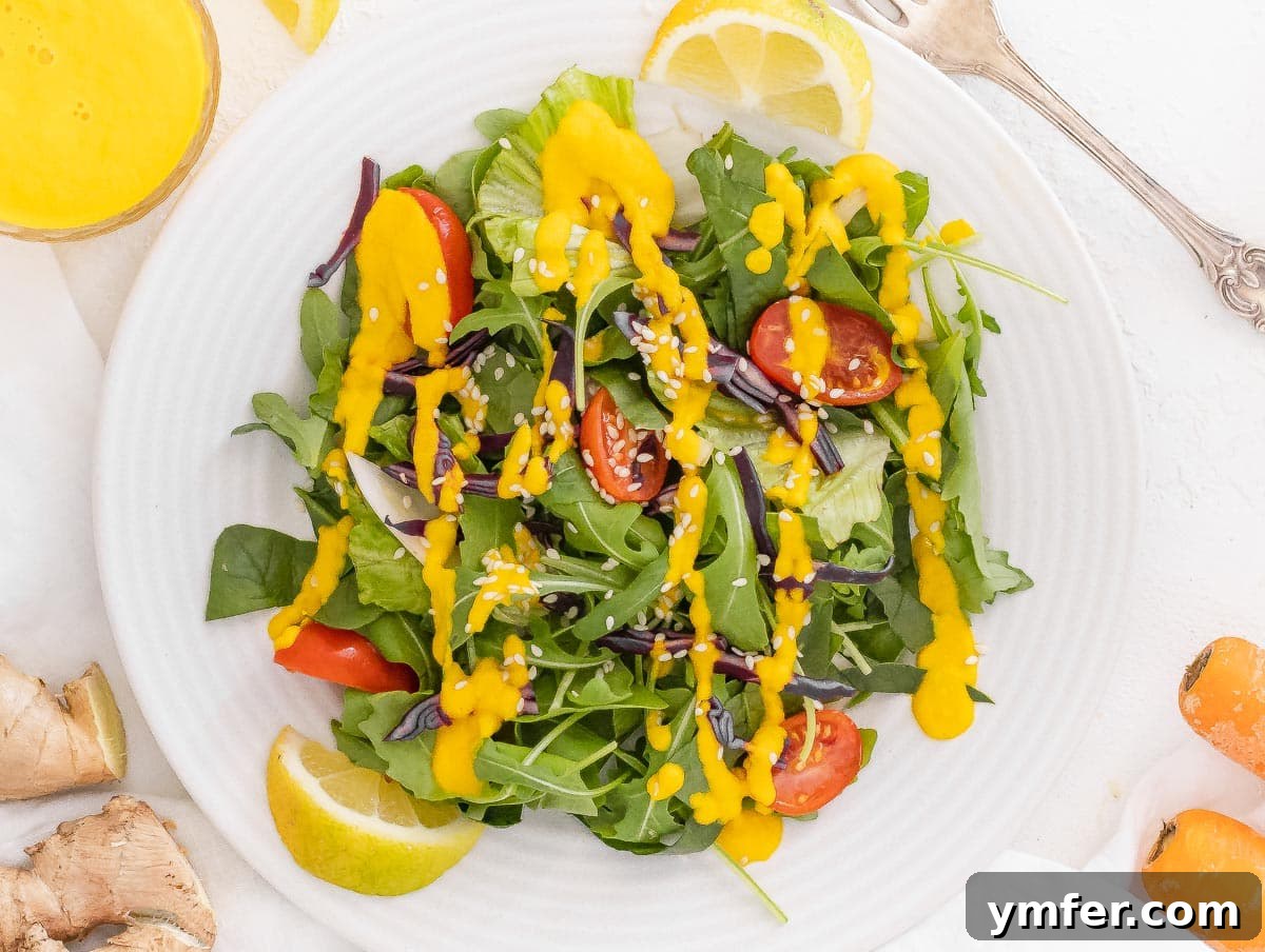 Vibrant Carrot Ginger Dressing 8 A fresh green salad generously topped with carrot ginger dressing and sesame seeds.