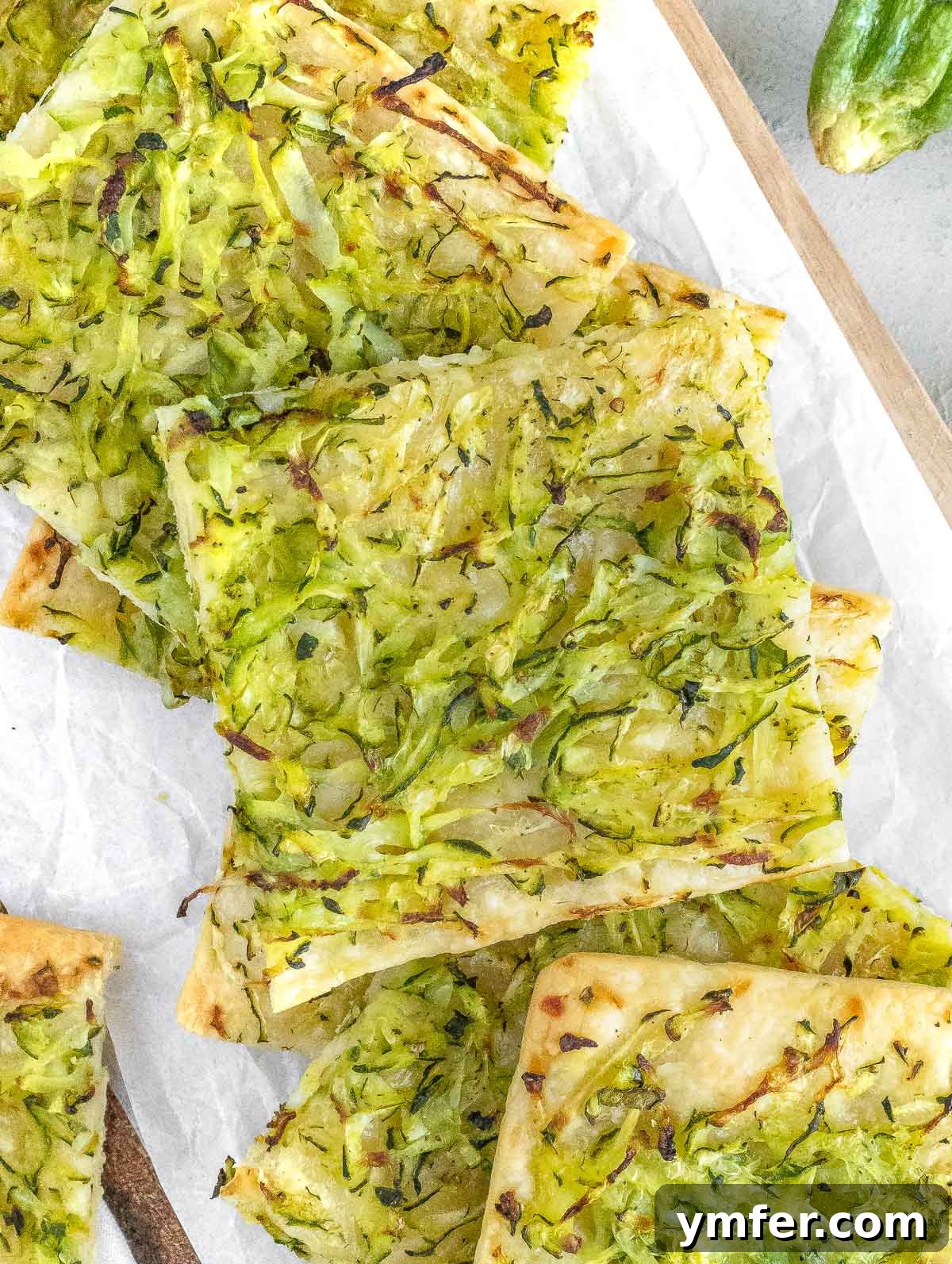 Rustic Zucchini Focaccia 3 Close-up of baked zucchini focaccia slices, showcasing the crispy crust and tender zucchini topping.
