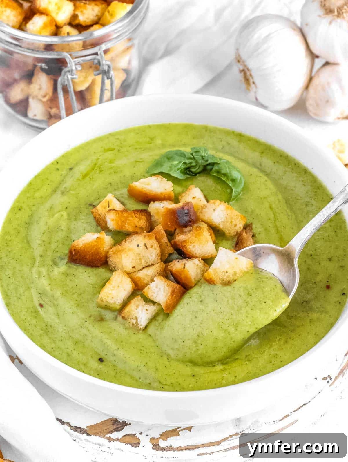 Creamy Zucchini Bliss 5 A bowl of creamy zucchini soup topped with homemade croutons, ready to be served.
